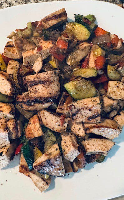 Grilled chicken with mixed vegetables, seasoned and cooked to perfection.