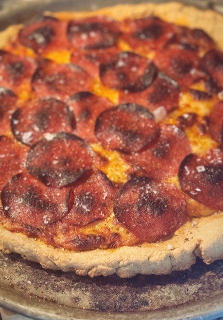 Close-up of a pepperoni pizza with melted cheese and crispy crust.